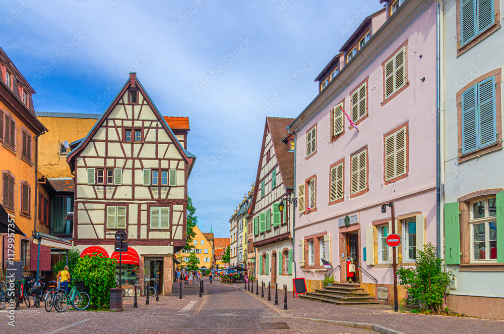 Fototapeta premium Old town Colmar city historic centre Grand Rue street with old houses medieval buildings half-timbered style colorful façade with shutters windows in summer day, Alsace Grand Est region, France