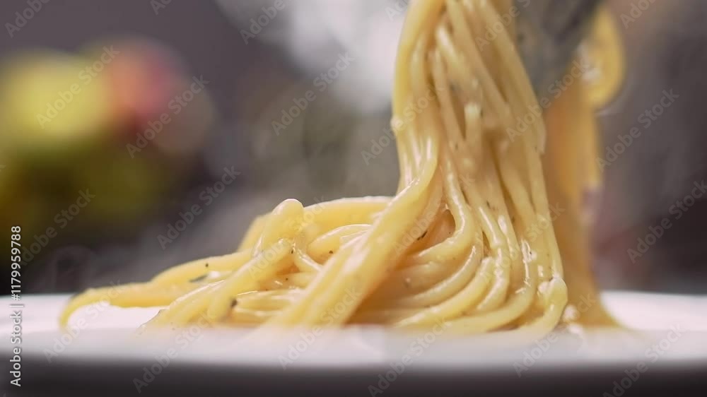 Chef puts finished spaghetti pasta onto a plate.