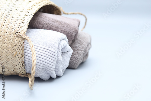 Closeup natural cotton towels in bamboo basket.Stylish interior  eco design with copy space.