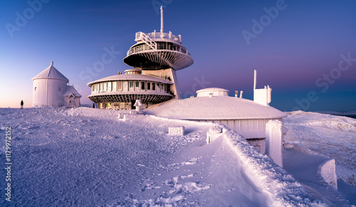 Fototapeta Naklejka Na Ścianę i Meble -  architecture of meteorological observatory station on Snezka summit during winter sunrise in Krkonose mountains on Poland and Czech republic border