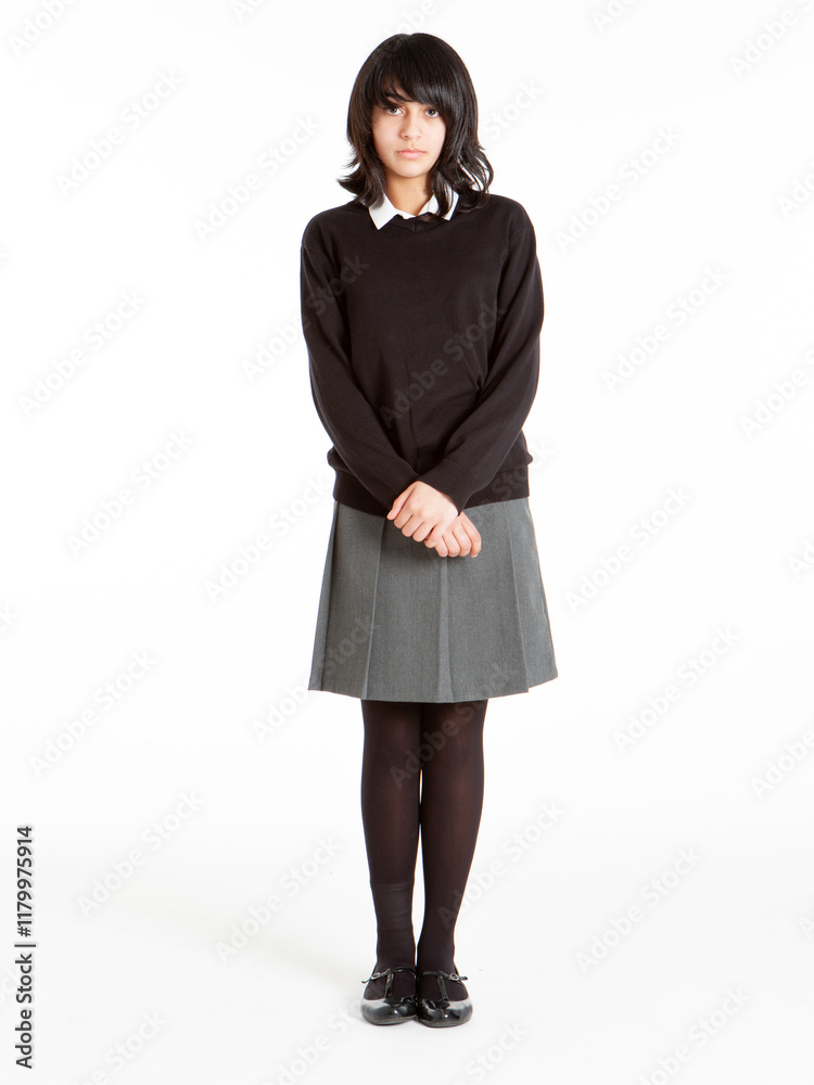 Early Teenage Students: Nervous Girl. A nervous looking early teenage girl in school uniform isolated against a white background. Early Teenage Students: Nervous Girl. A nervous looking early teenage girl in school uniform isolated against a white background.
