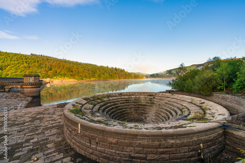 Ladybower reservoir dam wall and bellmouth spillwa in Peak District, UK