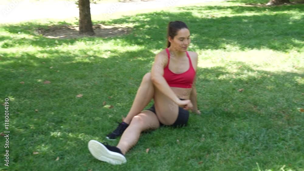 A woman is peacefully stretching her legs in a park, focusing on tranquility and flexibility A woman is peacefully stretching her legs in a park, focusing on tranquility and flexibility