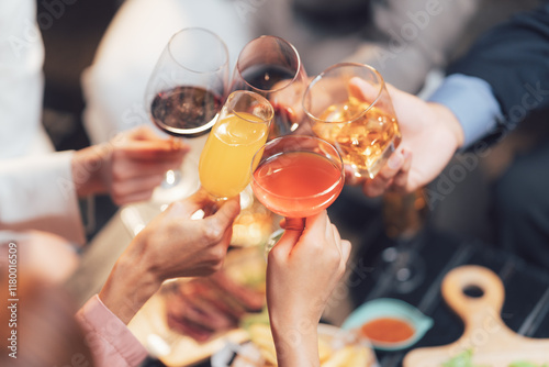 Cheers to Togetherness: A captivating overhead shot of friends raising a toast with diverse drinks, symbolizing unity and celebration during a festive gathering.   photo