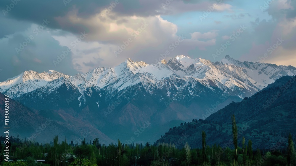 Breathtaking view of snowy mountain range under a dramatic sky. Breathtaking view of snowy mountain range under a dramatic sky.
