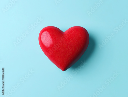 Bright red heart shape resting against soft blue background creates cheerful and vibrant display of affection and love