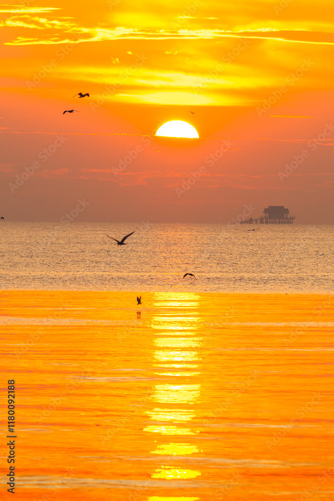 Sunrise over the sea in the morning with golden sunlight and see the Buddhist pavilion in the middle of the sea Sunrise over the sea in the morning with golden sunlight and see the Buddhist pavilion in the middle of the sea