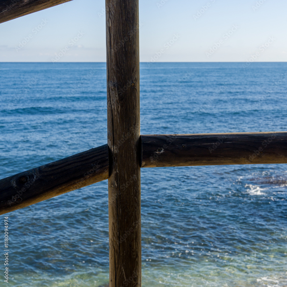 Wooden frame with the sea in the background on a promenade Wooden frame with the sea in the background on a promenade