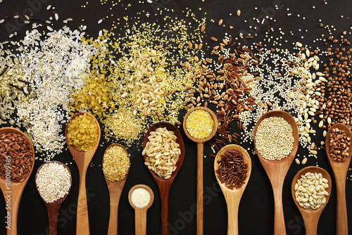 Colorful mix of grain varieties: oat and wheat, rice and millet, buckwheat and barley, quinoa and polenta. Food ingridients for healthy diet background, selective focus
