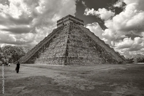 Majestic kukulkan pyramid at chichen itza dominating cloudy sky in monochrome photo