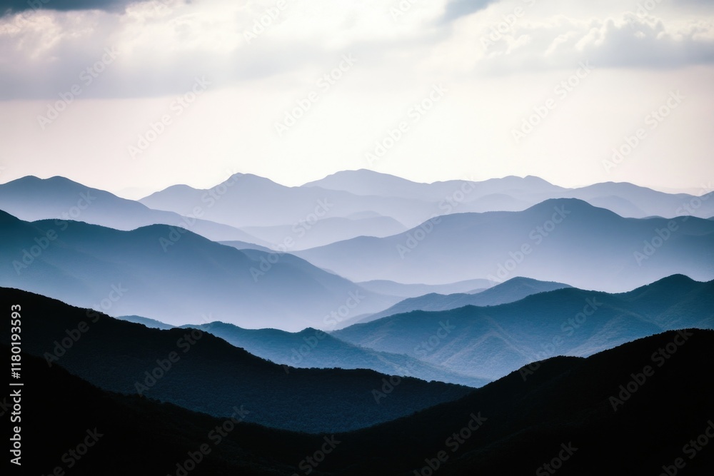 A distant view of a mountain range with varying elevations and terrain A distant view of a mountain range with varying elevations and terrain