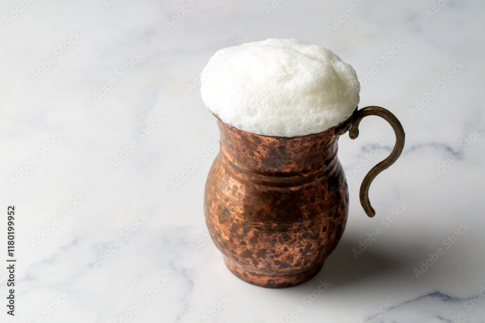 Glass cup of Turkish traditional drink ayran , kefir or buttermilk made from yogurt, healthy food