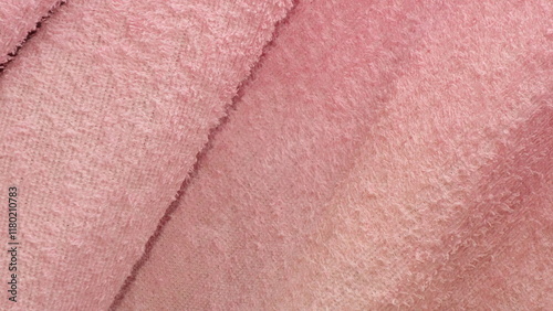 Close-up of soft, pink terrycloth fabric showcasing texture and warmth.