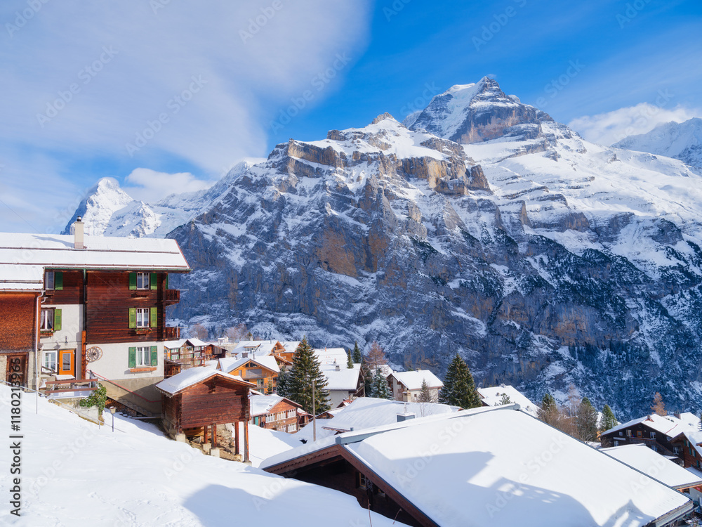 Murren village, Switzerland. Winter mountain landscape. Village among the mountains. Chalets and vacation homes. High cliffs and snow. View of the mountain in Switzerland.