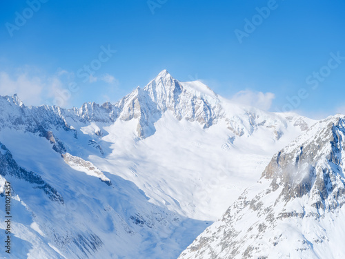 Winter mountain scene. High sharp rocks and snow. Cold weather and frost. View of the mountains. Photo for postcards, backgrounds, wallpapers.