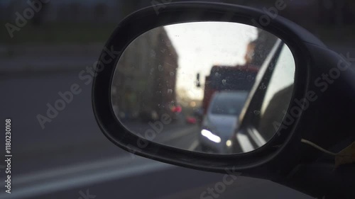 Reflection of the city in the outside rear view mirror of a car