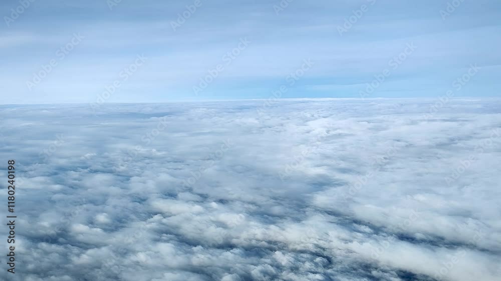 A view from a plane's porthole on the horizon when flying in the sky between layers of clouds (stratus clouds) A view from a plane's porthole on the horizon when flying in the sky between layers of clouds (stratus clouds)