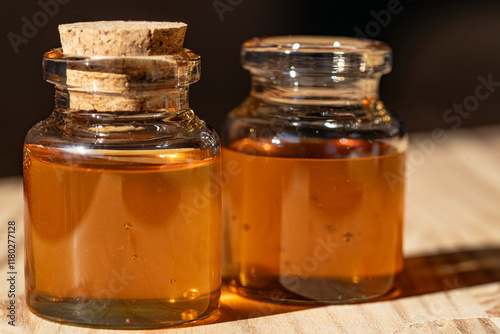 jars with honey in the sunlight on the wooden table