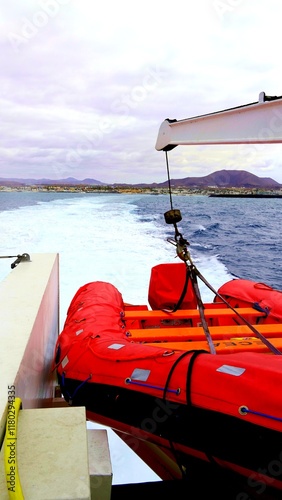 Ferry leaving canary islands with inflatable life raft on stern