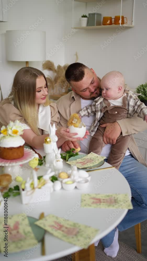 Family celebrates Easter at decorated table. Concept of celebrating Easter. Family celebrates Easter at decorated table. Concept of celebrating Easter.