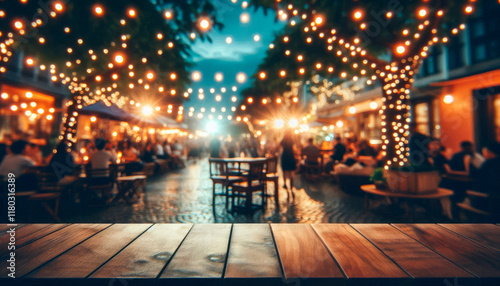Wooden empty tabletop for product on horeca street market with group of people in blur. Atmosphere lively and social in summer evening