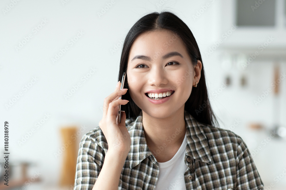 Cheerful young asian lady having healthy breakfast and talking on phone, smiling and looking at copy space. Pretty woman sitting at kitchen, eating oatmeal and calling girlfriend or lover Cheerful young asian lady having healthy breakfast and talking on phone, smiling and looking at copy space. Pretty woman sitting at kitchen, eating oatmeal and calling girlfriend or lover