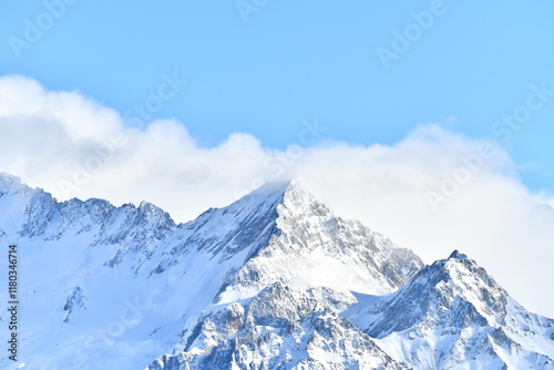 French alps on a sunny day under the clouds by winter covered with snow