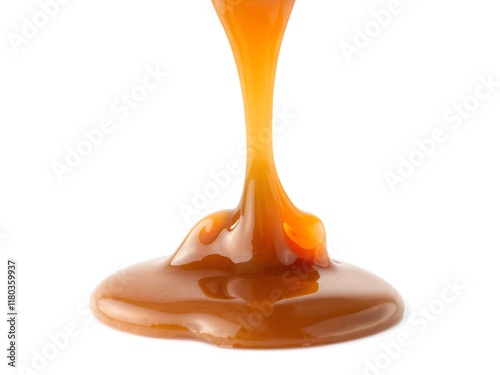 A rich caramel drip captured mid-flow, with a glossy texture and warm tones, isolated on a white background. Perfect for dessert designs photo