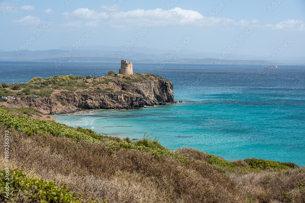 Landscape of the cliffs of Sant'Antioco with a watchtower and the turquoise sea on a sunny day