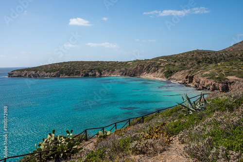 Obraz na płótnie Landscape of the coast of the island of Sant'Antioco with the turquoise sea and the red cliffs on a sunny day w salonie