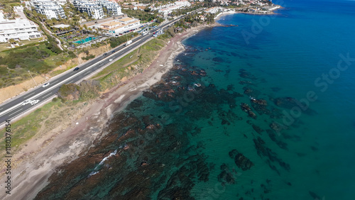 Aerial drone photo of the beautiful beach front in the town of Mijas in Spains Costa Del Sol showing the rocky beach front known locally as Playa del Chaparral on a sunny day