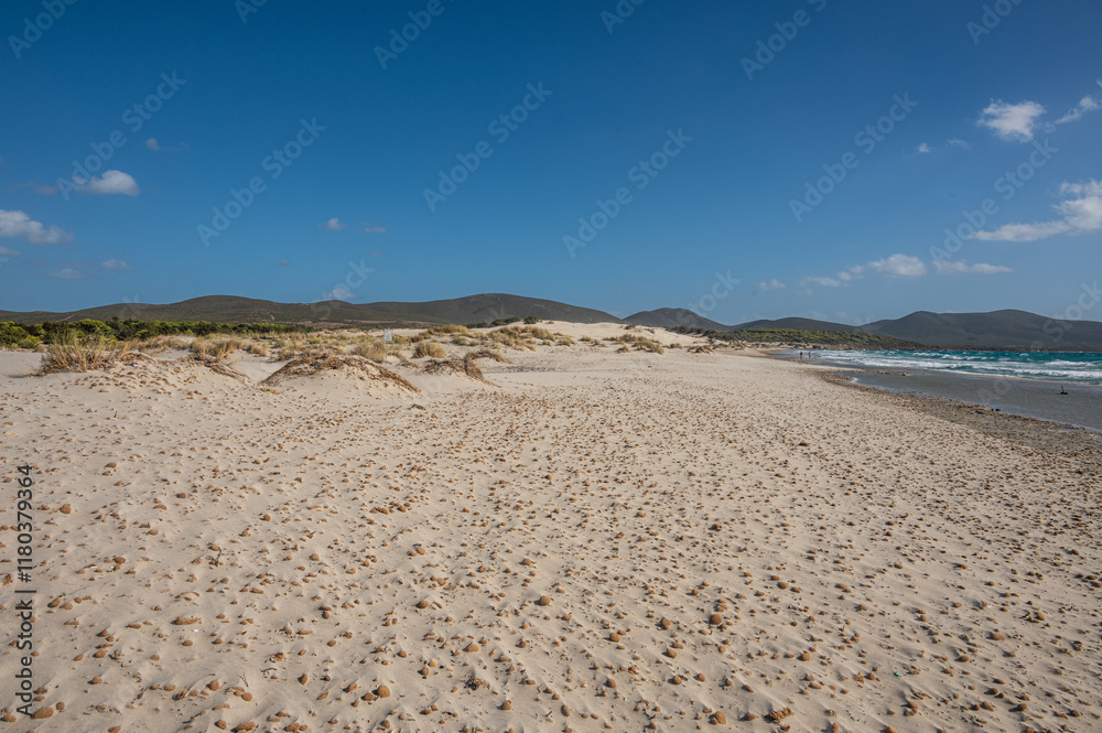 The beautiful beach of Is Solinas in Sardinia with its high white dunes on a windy day