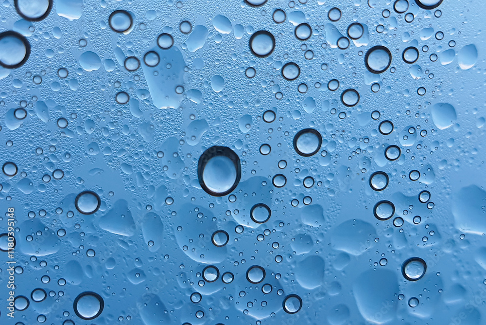 A captivating close-up of water droplets on a blue surface, showcasing varying sizes and textures, evoking a sense of freshness and tranquility. A captivating close-up of water droplets on a blue surface, showcasing varying sizes and textures, evoking a sense of freshness and tranquility.