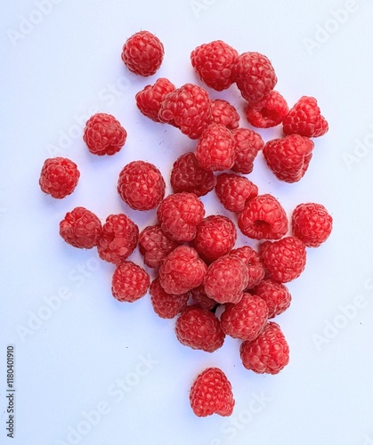 Red raspberries on white background with space for copy photo