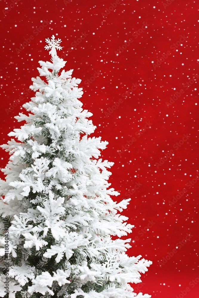 A snowy Christmas tree against a red background, evoking holiday cheer. A snowy Christmas tree against a red background, evoking holiday cheer.
