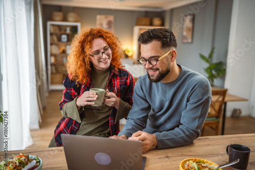 couple use laptop for work or fun while have break for lunch