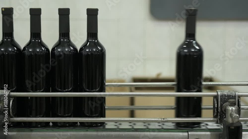 Bottles on the conveyor line in wine bottling and production. photo