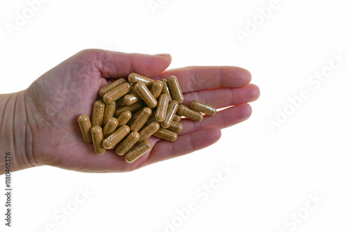 Guarana capsules in hand isolated on white background. Capsules with guarana powder. Natural energy drink. Dietary supplements in nutrition
