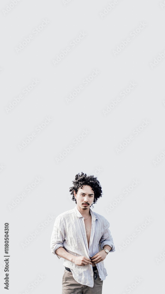 A vertical mobile-friendly format shot of a stylish biracial young man with curly hair on the white solid background, wearing an open linen shirt and textured trousers, with ample copy space above A vertical mobile-friendly format shot of a stylish biracial young man with curly hair on the white solid background, wearing an open linen shirt and textured trousers, with ample copy space above