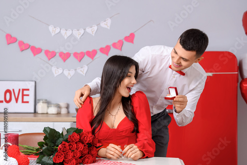 Young man proposing to his ...