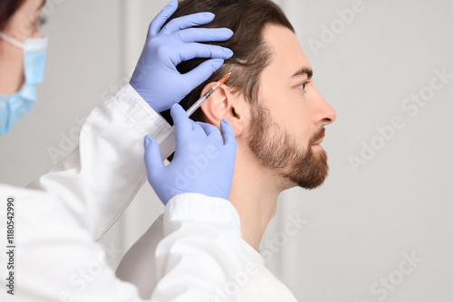 Young man receiving injecti...