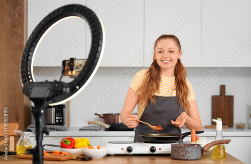 Female blogger frying food ...