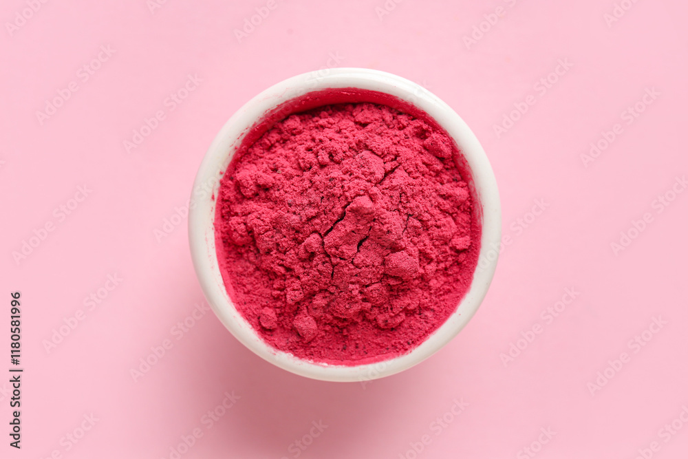 Bowl with color powder pigment on pink background Bowl with color powder pigment on pink background