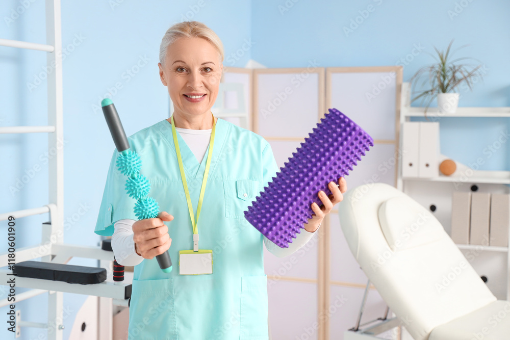 Female physiotherapist with massage rollers in rehabilitation center Female physiotherapist with massage rollers in rehabilitation center