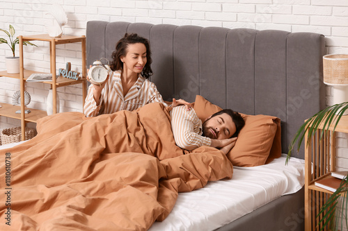 Young woman with alarm cloc...