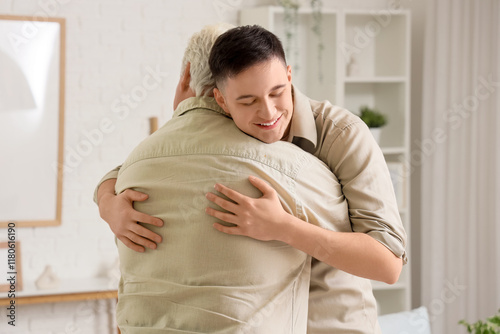 Young man hugging his fathe...