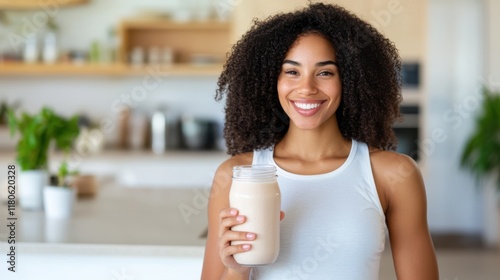 Woman joyfully blending a smoothie in a cozy kitchen at home