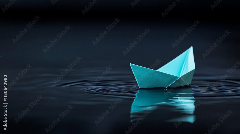 Obraz premium A small light blue paper boat floats on dark water, creating ripples.