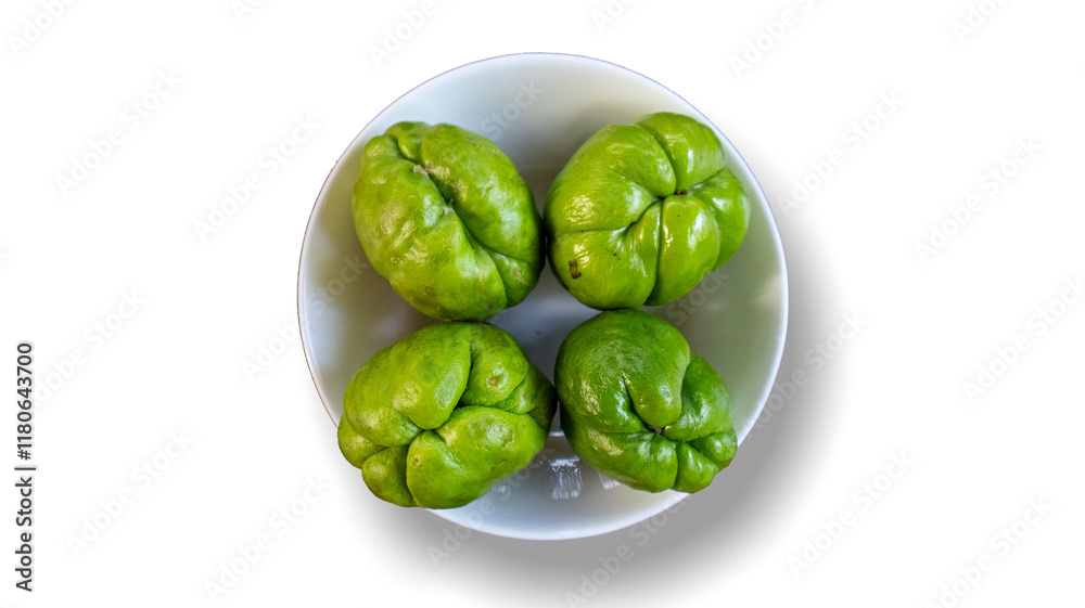 Close-up shot of fresh chayote in a plastic bowl over an isolated white background. Top view. Close-up shot of fresh chayote in a plastic bowl over an isolated white background. Top view.