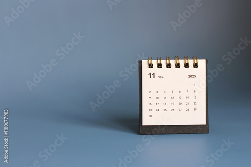 Monthly calendar template for the new year 2025 desk calendar,isolated on Blue background. photo